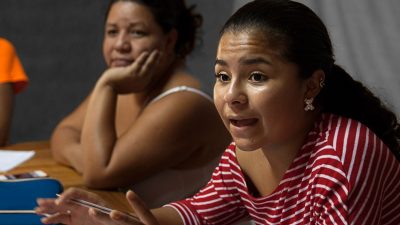 Maria Fernanda consults with some of the others in her organization